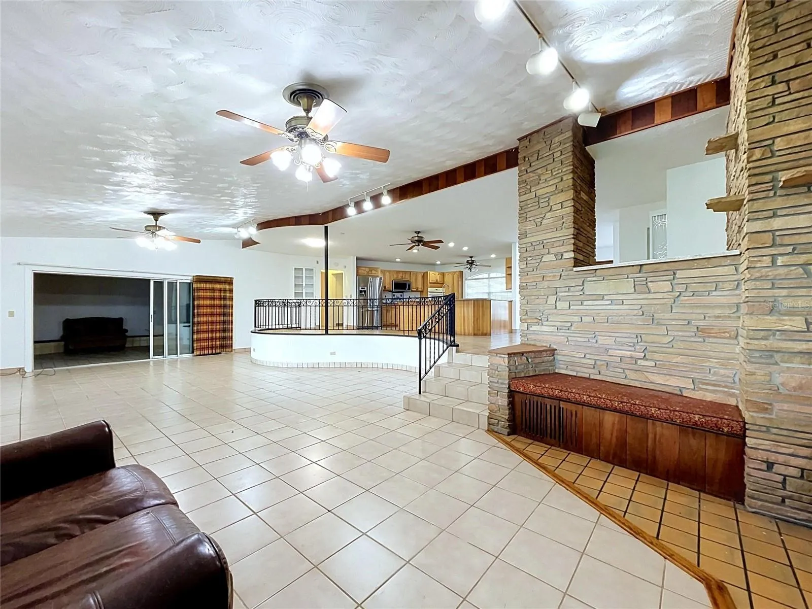 Living area with tile flooring and kitchen access