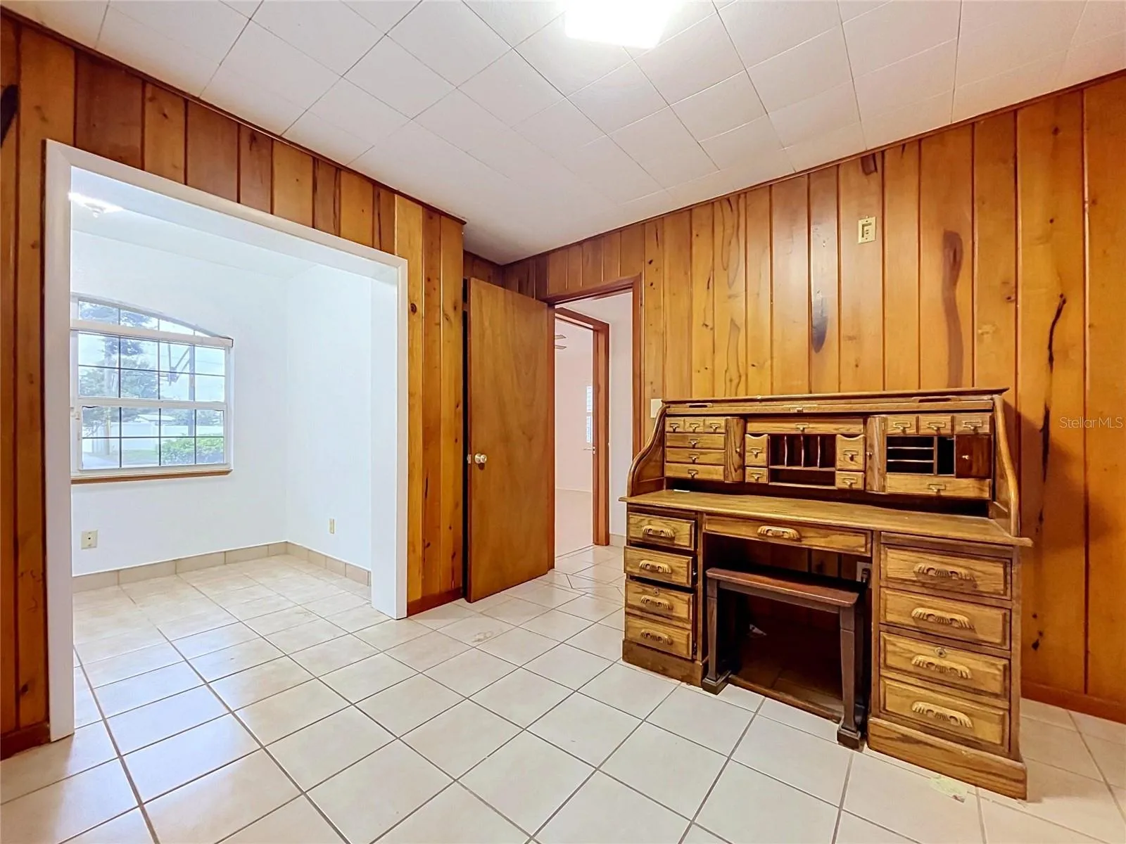 Bedroom 3 with wood-paneled walls (desk - personal property not included)