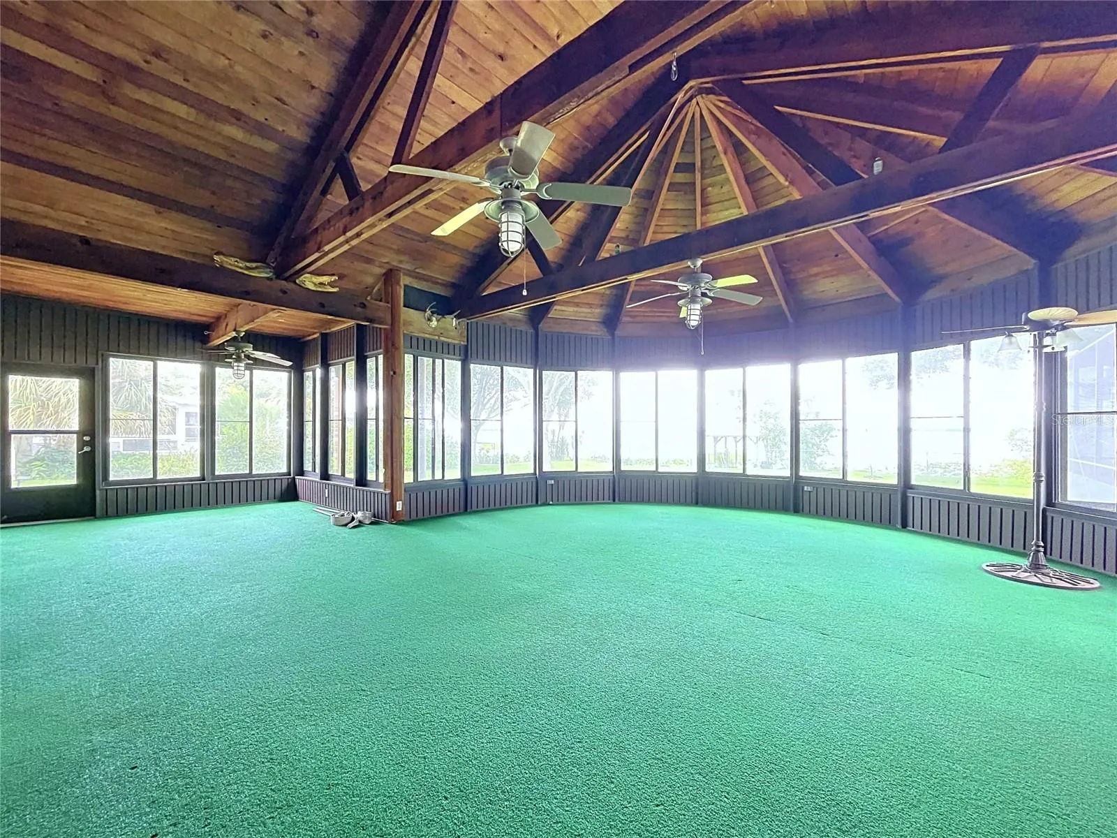 Lanai with large windows and vaulted wood ceiling