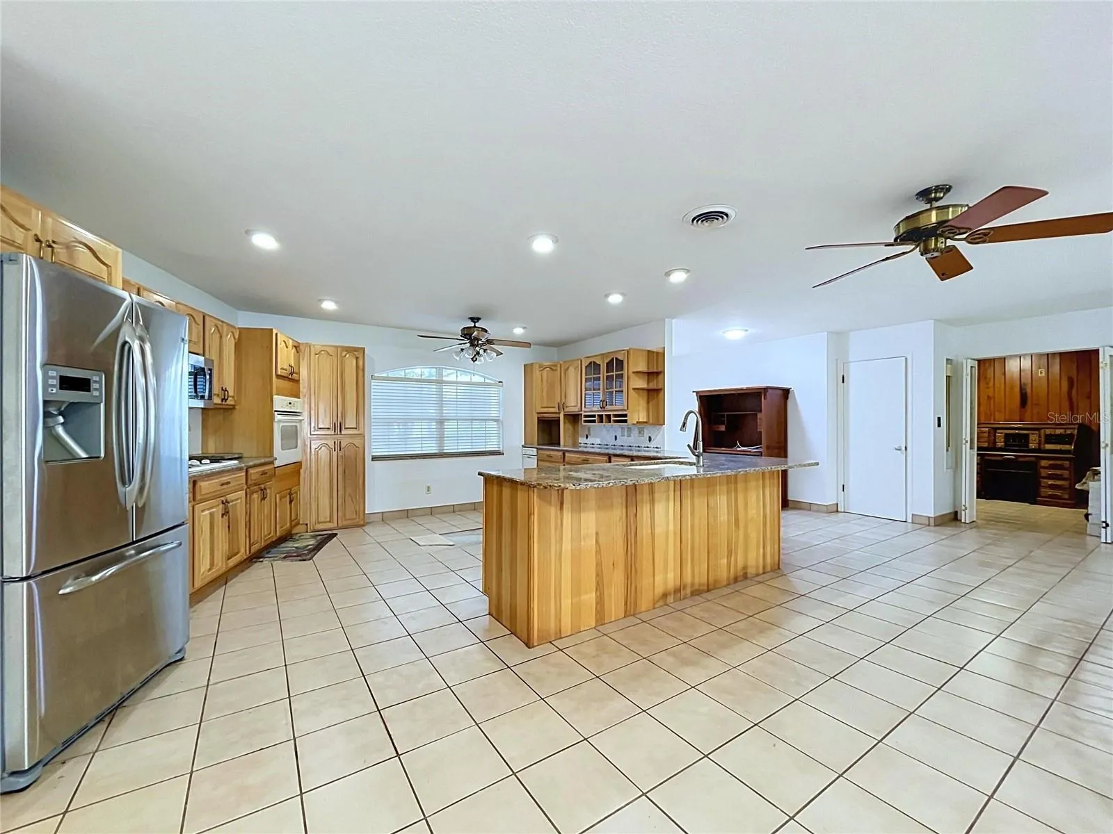 Kitchen with center island and tile flooring