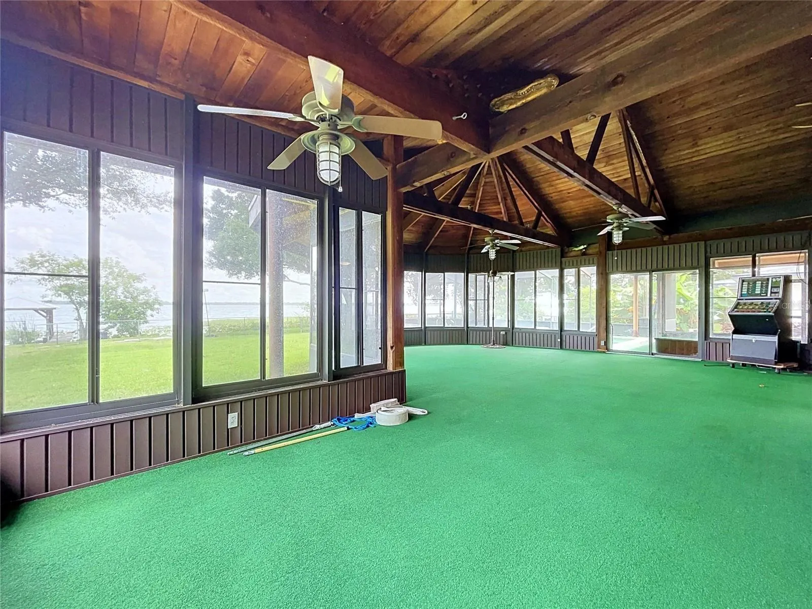 Lanai with large windows and vaulted wood ceiling
