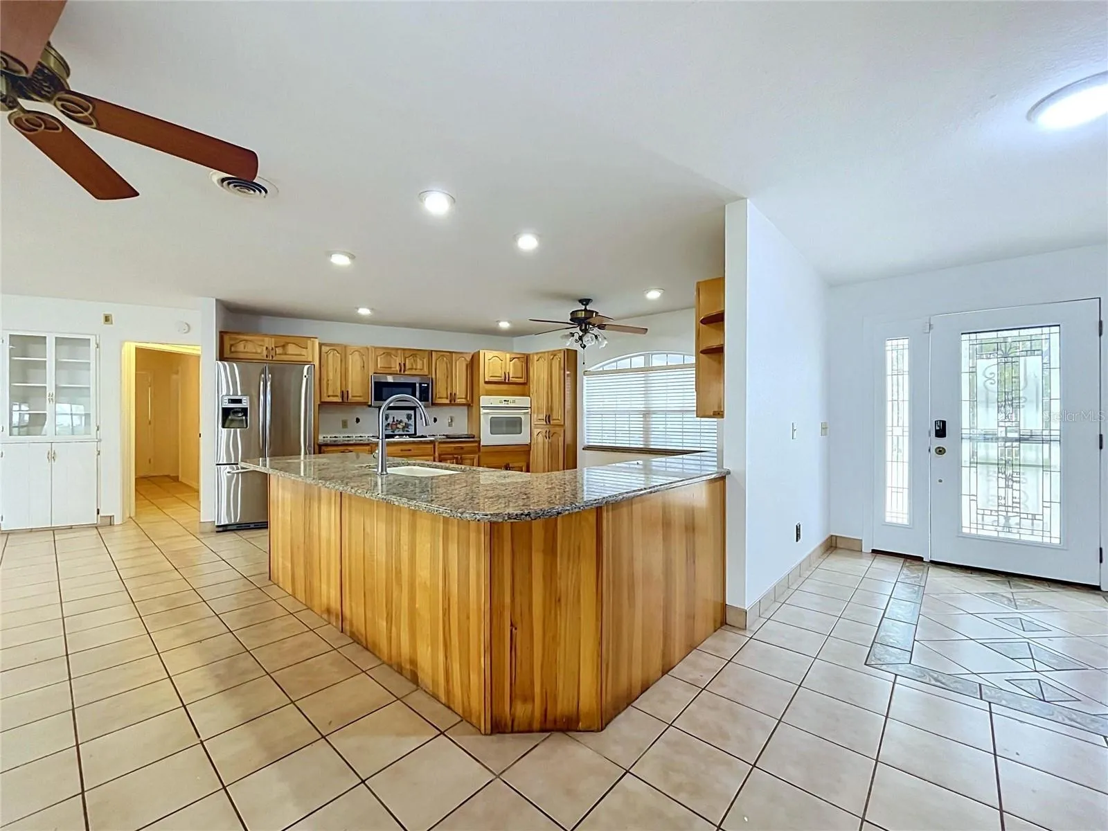 Kitchen with center island and adjoining living area