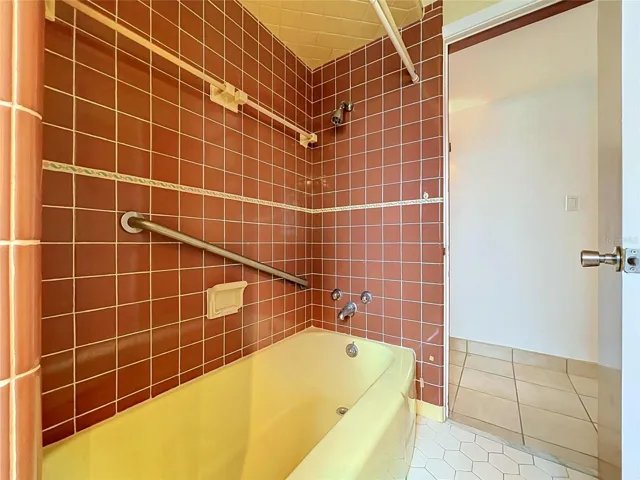Bathroom 2 bathtub with tiled walls and shower