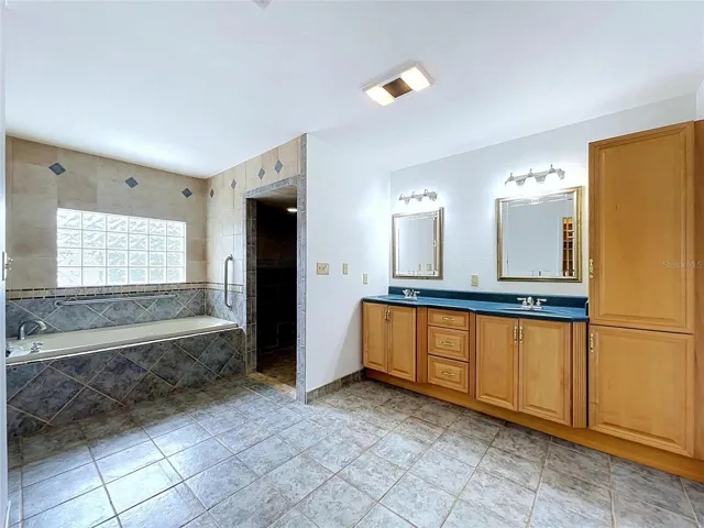 Bathroom 3 vanity with cabinetry and mirrors