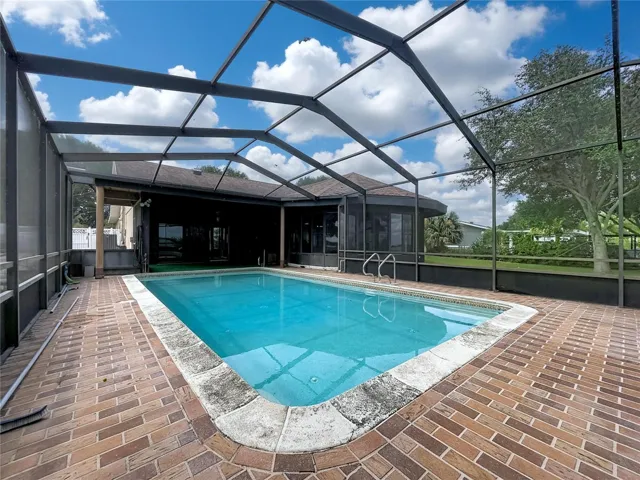 In-ground pool with screened enclosure