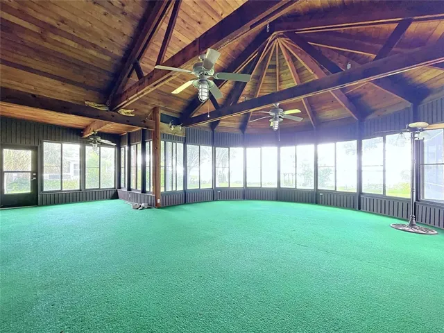 Lanai with large windows and vaulted wood ceiling