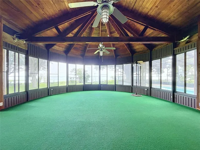 Lanai with large windows and vaulted wood ceiling
