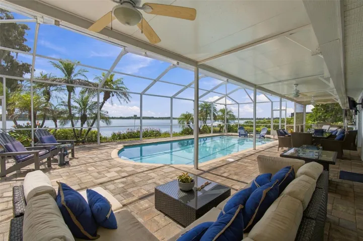 Covered lanai - Brick paved, tropical landscape