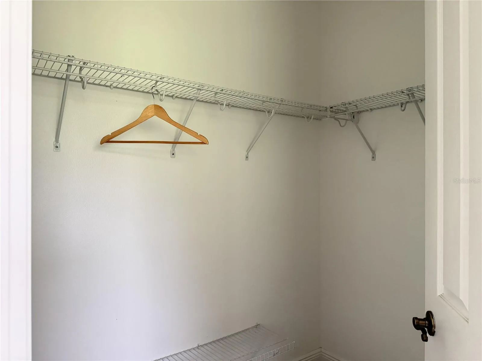 Primary walk-in closet with wire shelving.