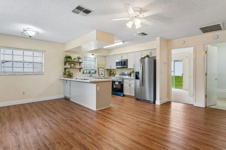 Living area view with kitchen, bedroom and bathroom