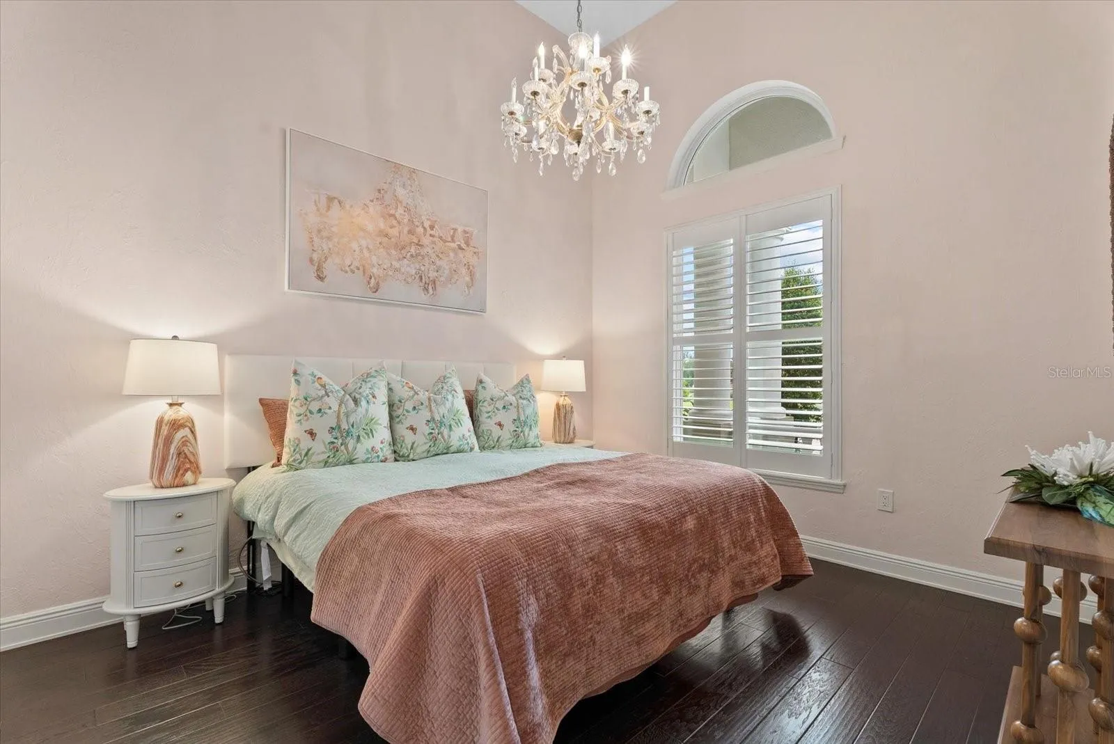 Also on the first floor is a spacious second bedroom with arched window and hardwood floors