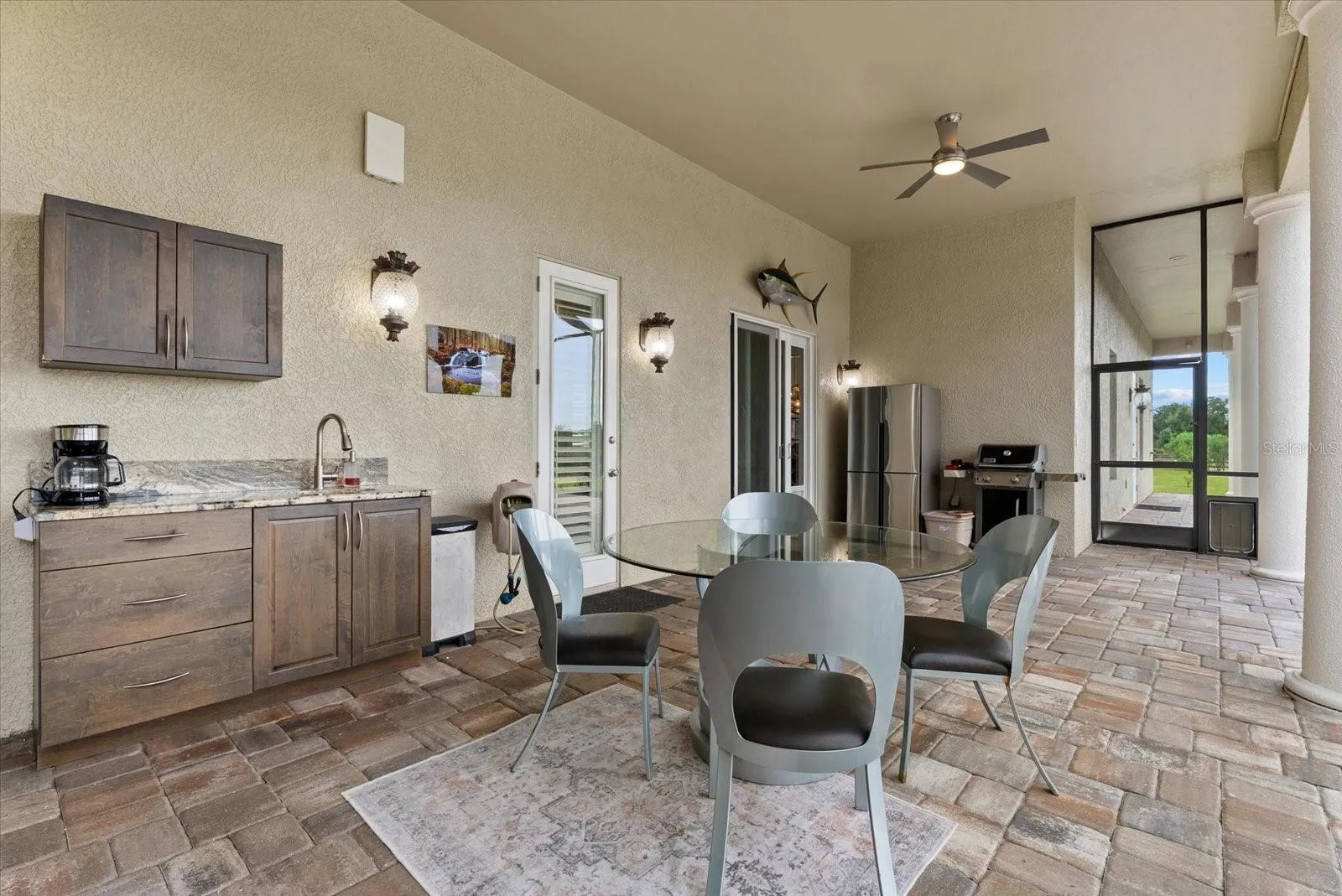 The second outdoor lounge area is off the family room/kitchen area, and offers access to the half bath off the media room
