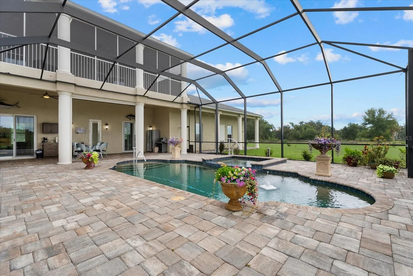 This view shows the upper lanai, and the lounge off the family room.  The door shown leads to a half bath
