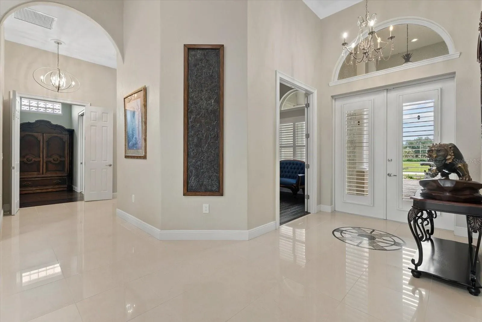 Looking back towards the front entry, door to the study and french doors entry to the primary suite