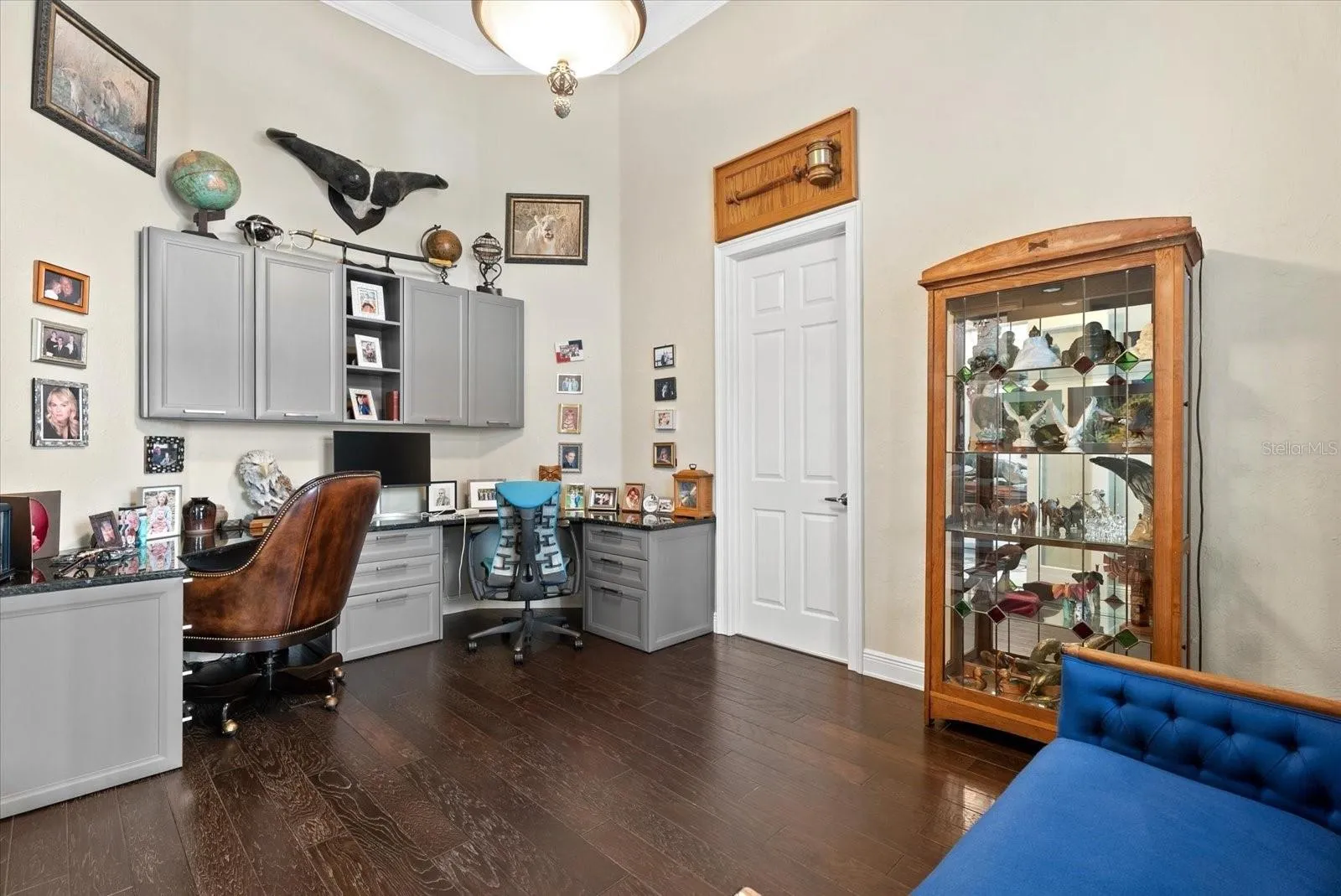 Located immediately to the right of the front entry lobby, you'll find a private office with wood floors, custome built-ins and entry to the hall leading to the garage on the northeast side of the home