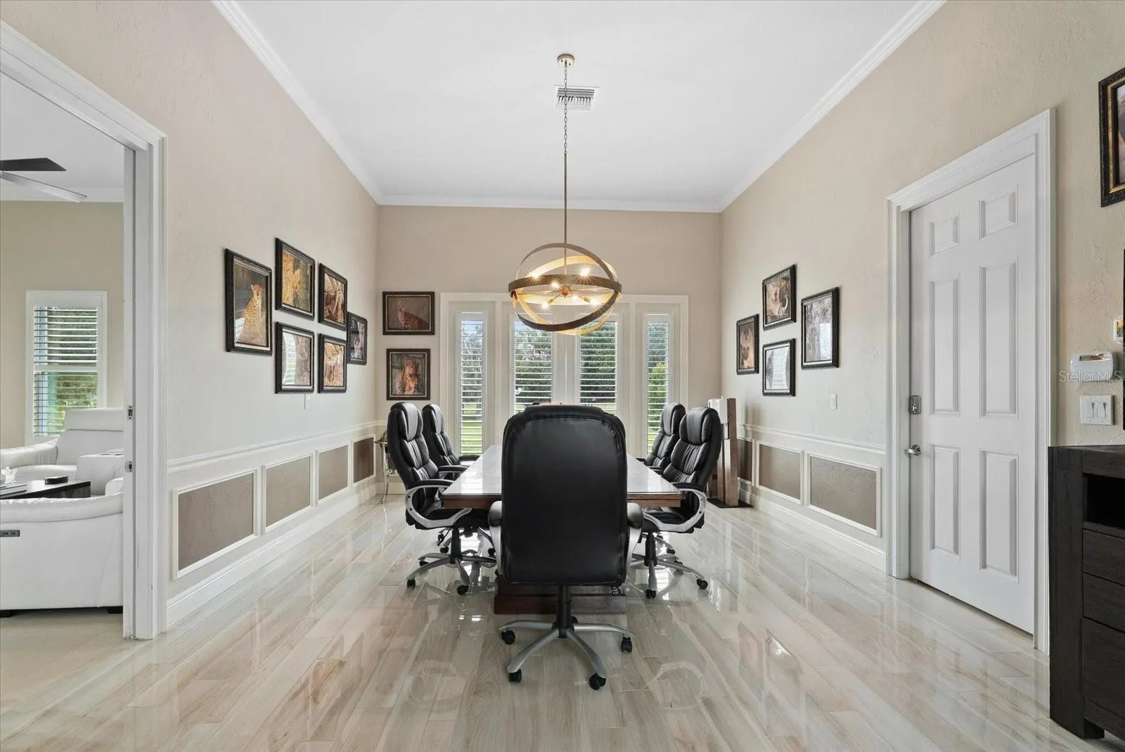 Just beyond the media room is a unique space - a full in-law suite/apartment that would serve many purposes. Thi first room is currently used as a conference room, but could also be a bedroom for the inlaw suite.