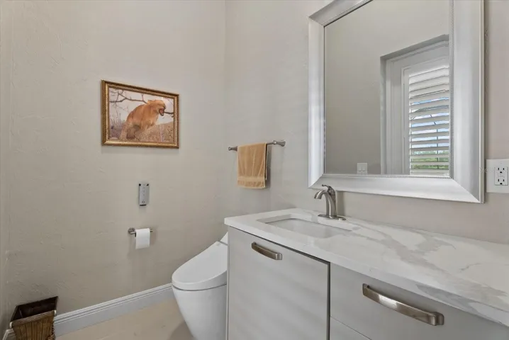 Half bath that leads to the pool deck