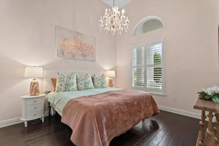 Also on the first floor is a spacious second bedroom with arched window and hardwood floors