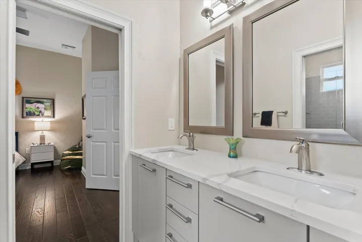 A Jack and Jill bathroom connects bedrooms three and fout, offering dual sinks and mirrors
