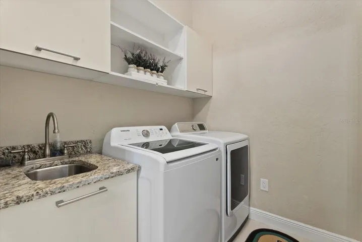 The laundry room is located on the first floor, just off the bonus room