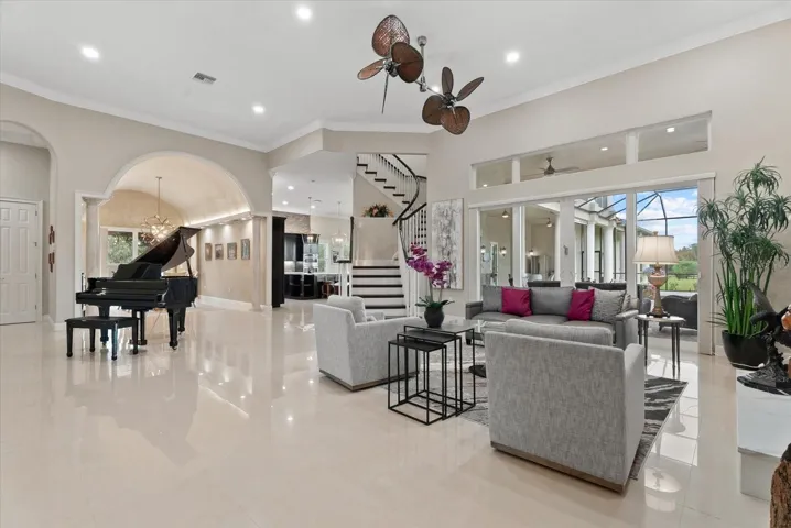 Sparkling tile floors, 12 ft ceilings, crown molding, clerestory windows, a winding staircase and custom wood trim set the tone for this wonderful front living room