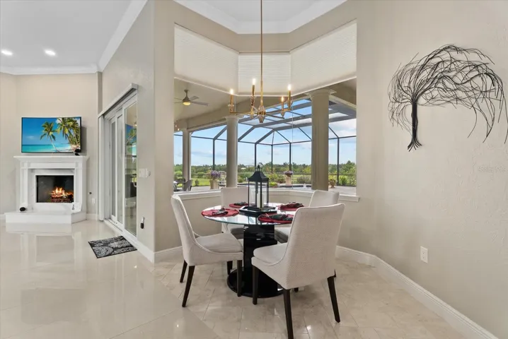 The breakfast nook is surrounded by aquarium glass windows looking out on the pool deck and pastures