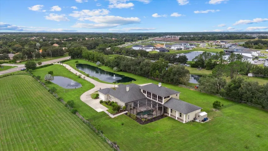This drone shot shows the property entrance and long driveway