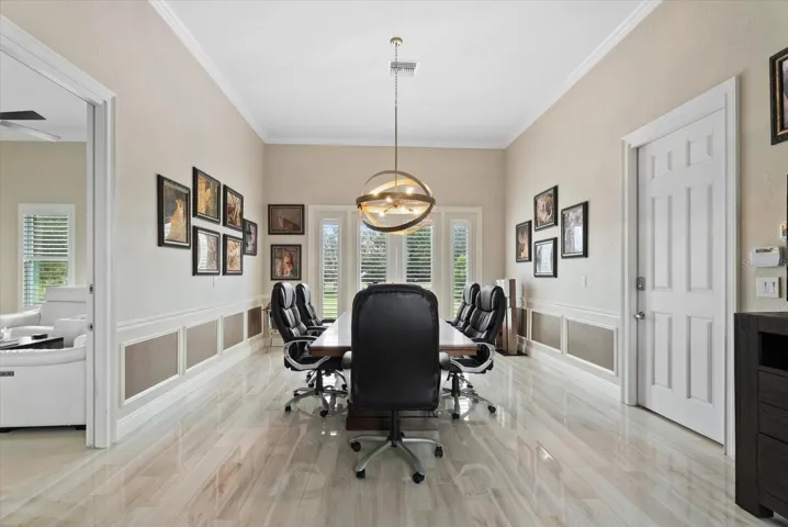 Just beyond the media room is a unique space - a full in-law suite/apartment that would serve many purposes. Thi first room is currently used as a conference room, but could also be a bedroom for the inlaw suite.