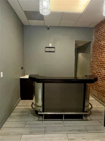 wet bar in front of kitchen entrance