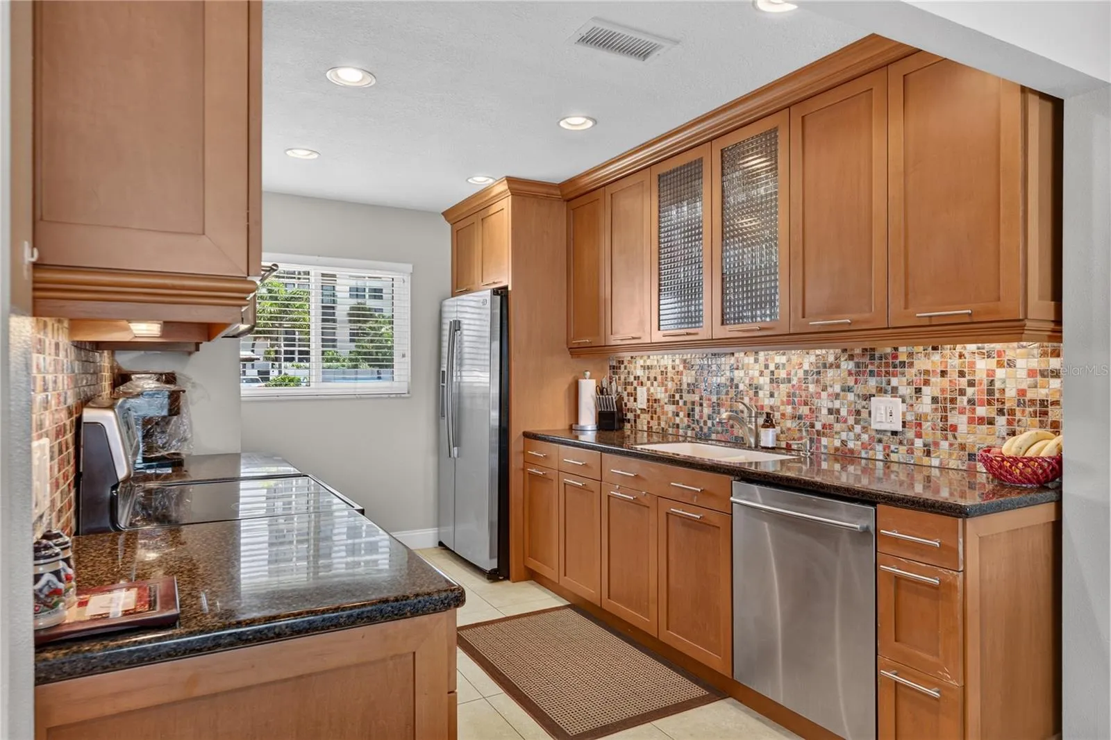 Kitchen with large windows letting in an abundance of light.