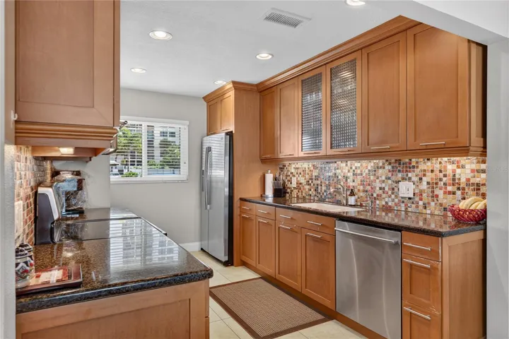 Kitchen with large windows letting in an abundance of light.