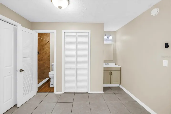 primary bedroom including bathroom and sink