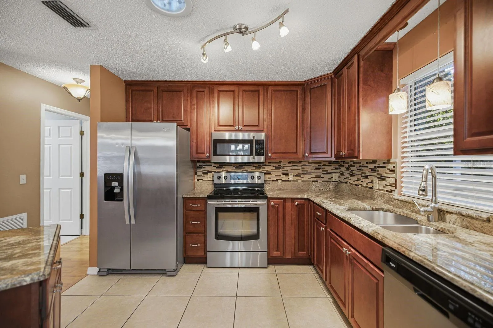 Granite, stainless and wood cabinets