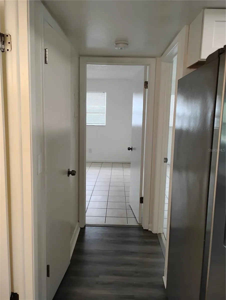 Hallway view of Bedroom 2.  Bedroom 1 entrance on the right. Bathroom entrance on the left.