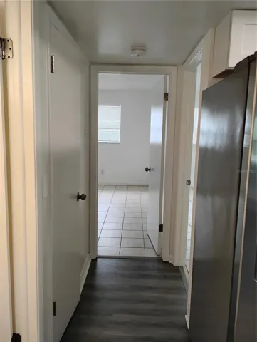 Hallway view of Bedroom 2.  Bedroom 1 entrance on the right. Bathroom entrance on the left.