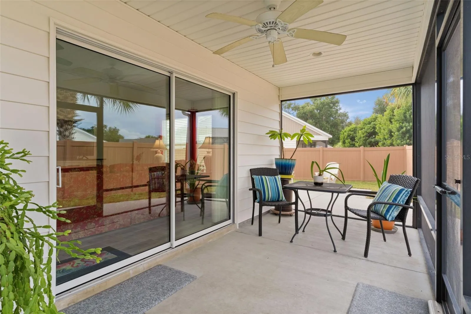 Covered, screen lanai leads to the large patio area