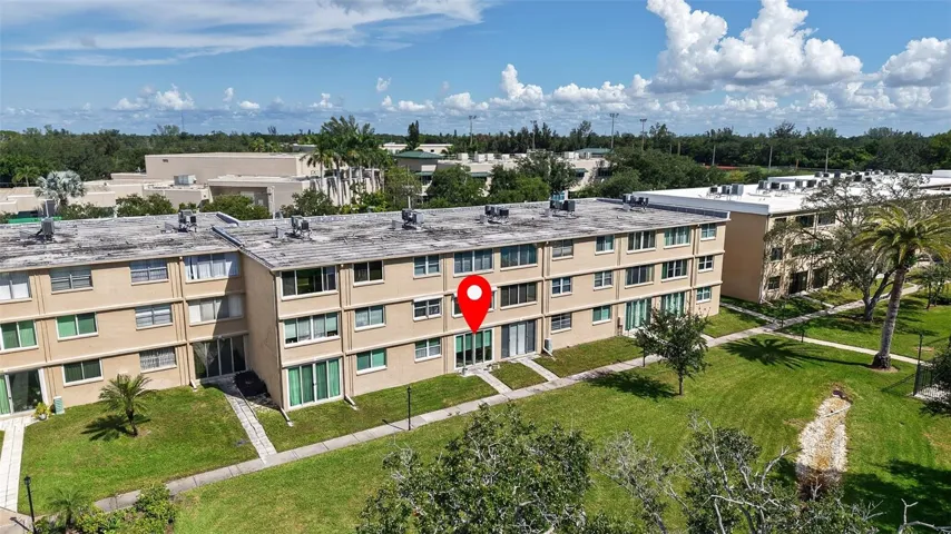 View of condo and courtyard with sidewalks