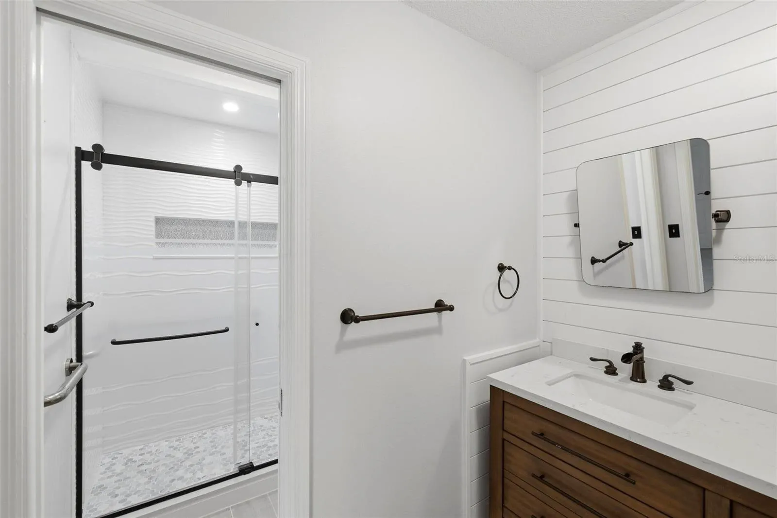 Separate room in primary bathroom for walk-in shower and toilet.
