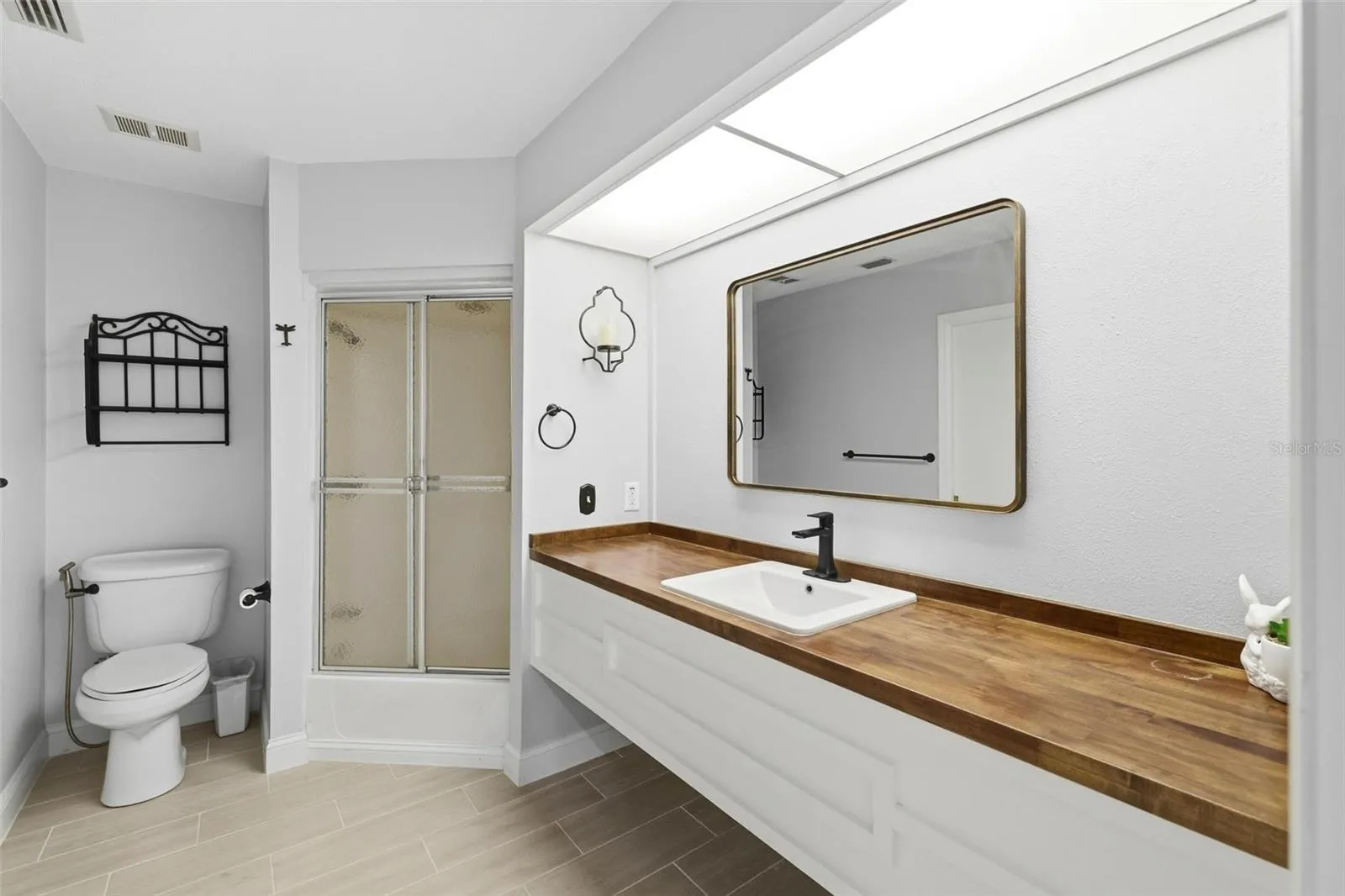 Guest bathroom with walk-in shower and large vanity.