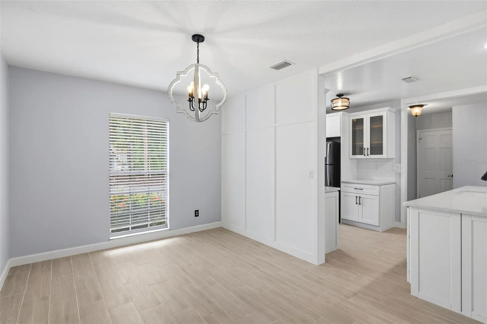 Dining area with plenty of space for a large dining table along with accessory pieces.