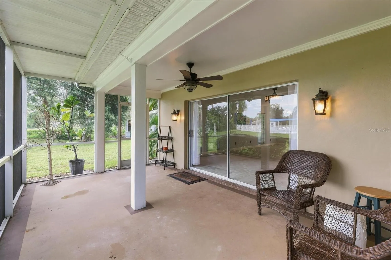 Gracious lanai overlooking rear yard and pool area