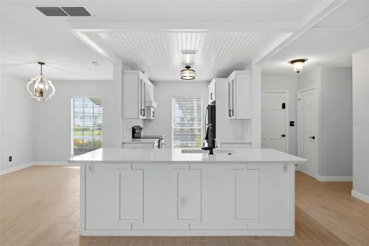 The large breakfast bar divides kitchen from the living area.  Plenty of room for bar stools for quick meals and extra counter space.