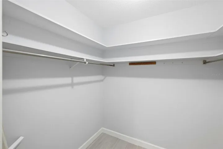 Large walk-in closet for primary bedroom.