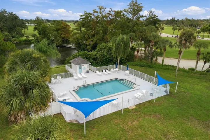 View of pool, lake and golf course area