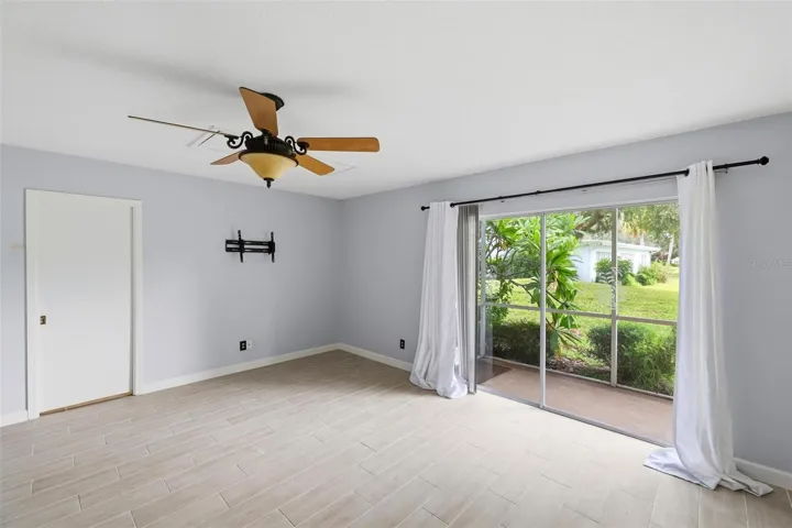 View from primary bedroom into lanai and rear yard.
