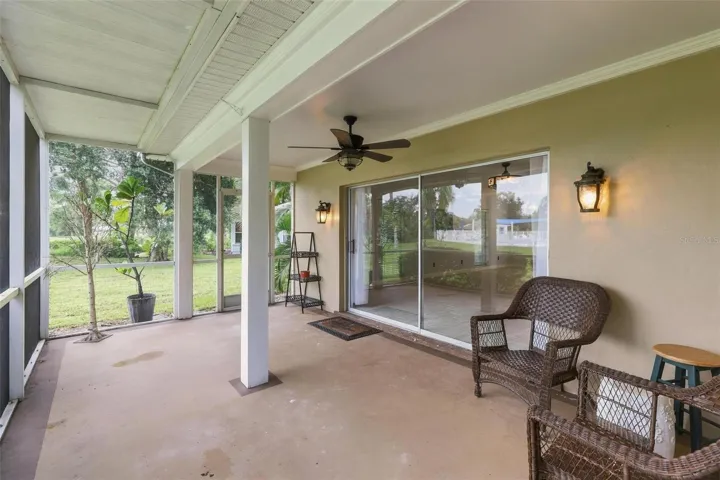 Gracious lanai overlooking rear yard and pool area