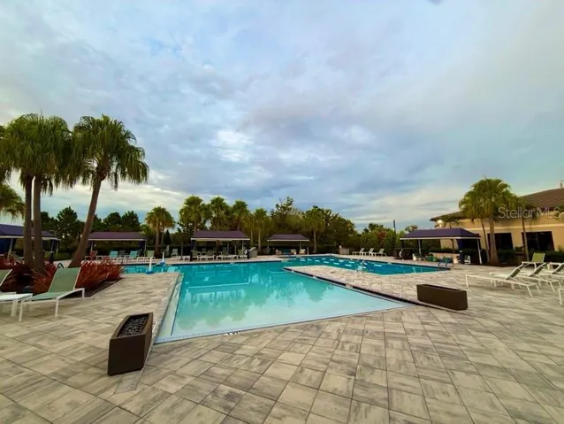 hot tub is behind the pool