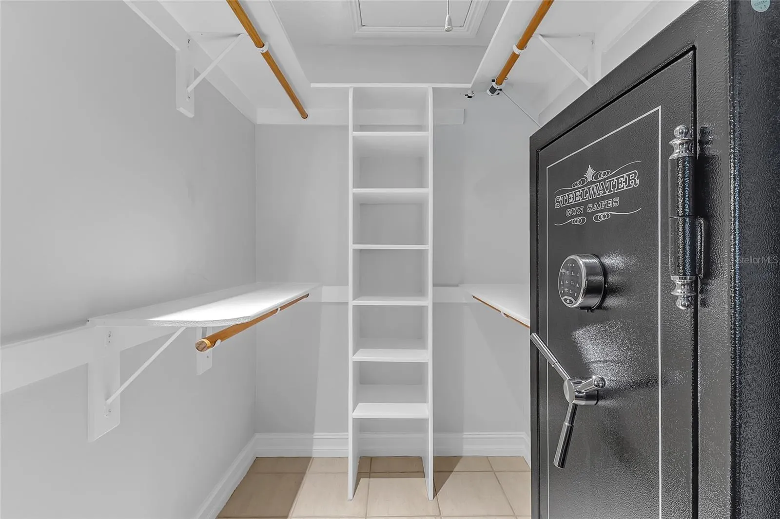 Primary Bedroom Walk-In Closet with Pull-Down Stairs Providing Access to Additional Attic Storage and Closet Space