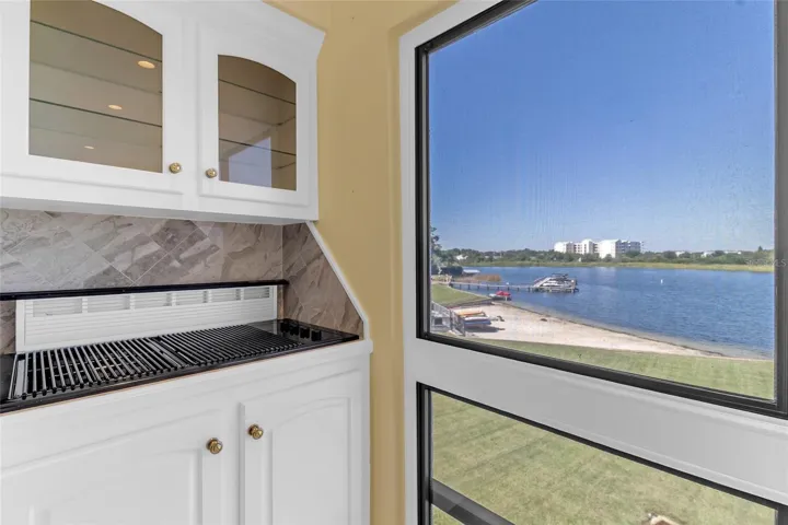 Built-In Grill Area with Custom Cabinetry and Beautiful Views of Lake