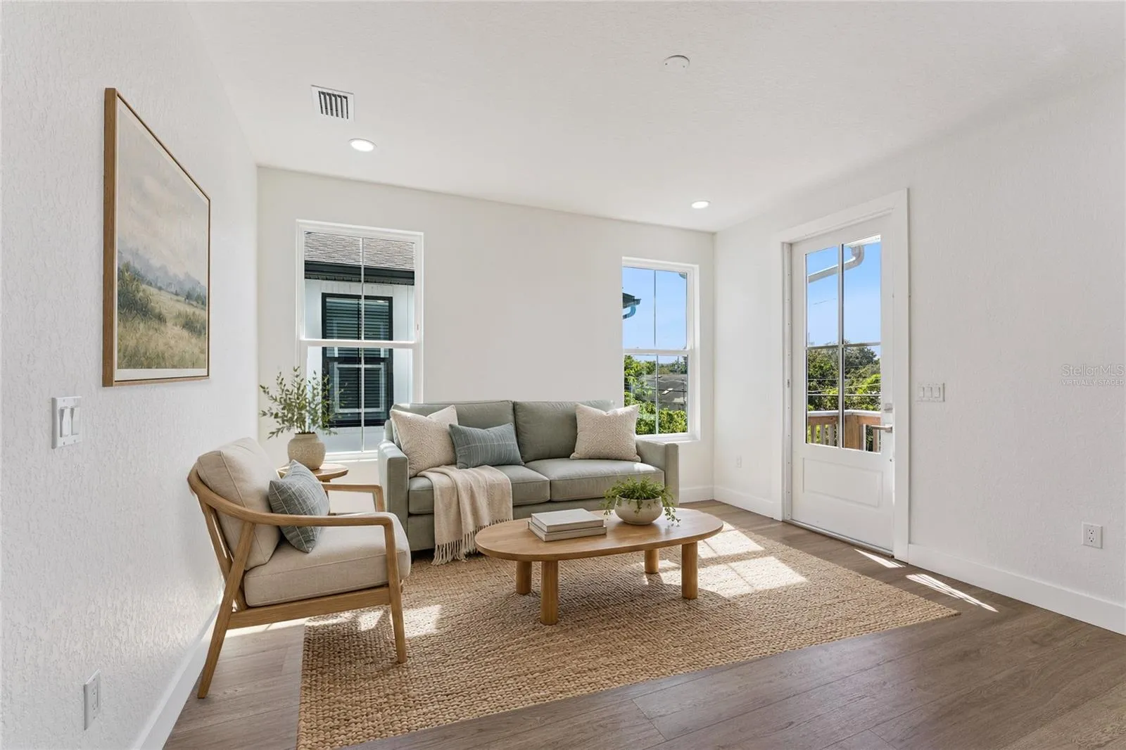 Virtually Staged - Tall windows and a glazed exterior door bring light into this room.